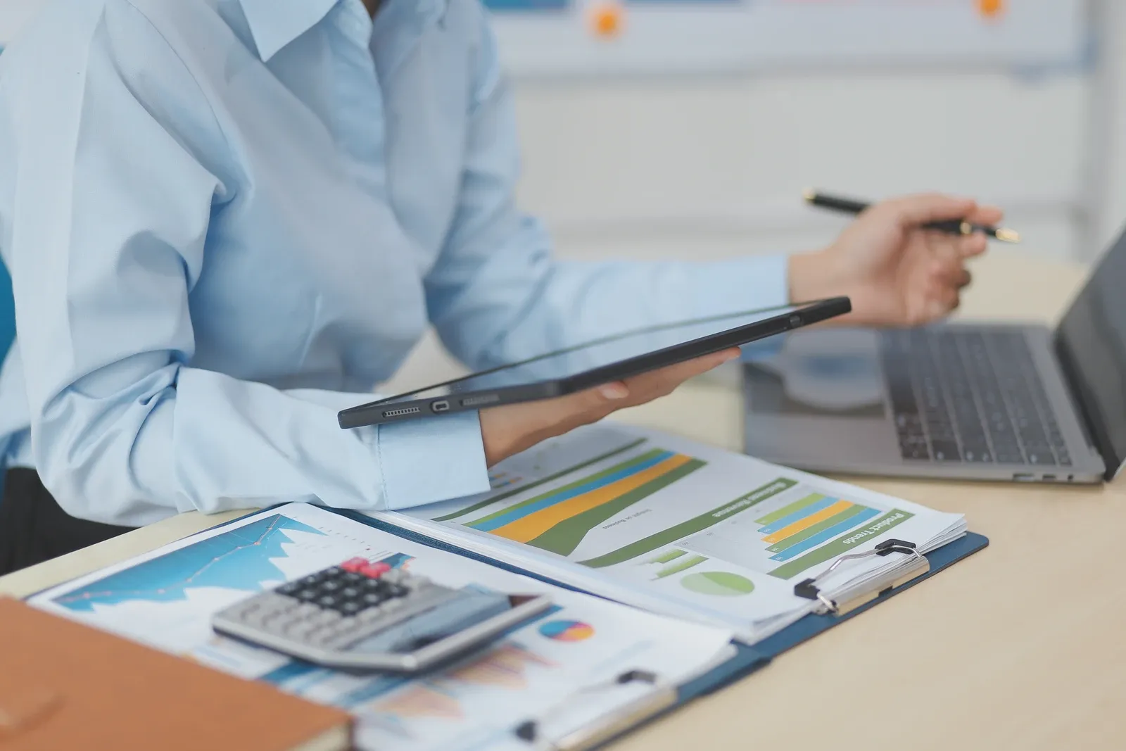 Accountant with spreadsheet and tablet
